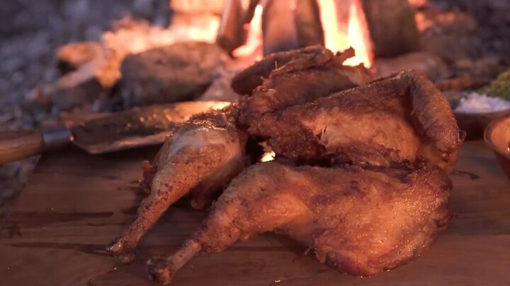Deep-frying a whole wild chicken outdoors: After cleaning and prepping the bird, coat it in flour an