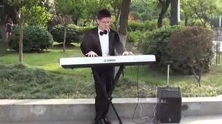 Street performer playing Joe Hisaishi's classic piano piece Kikujiro's summer previous record