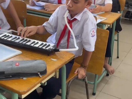 "The Little Harmonica Player on the Desk"