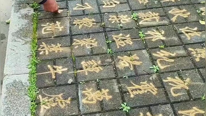 True masters are among the people: an elderly man uses sand to write the Hundred Family Surnames, ea