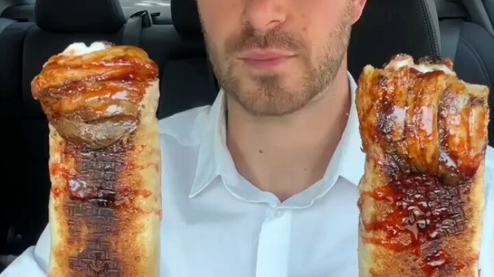 Consumer spending has plummeted! A white guy eats a $12 shawarma sold at a street stall.
