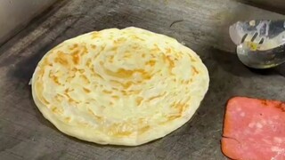 The hand-pancake vendor says he's going to show off his signature skill.