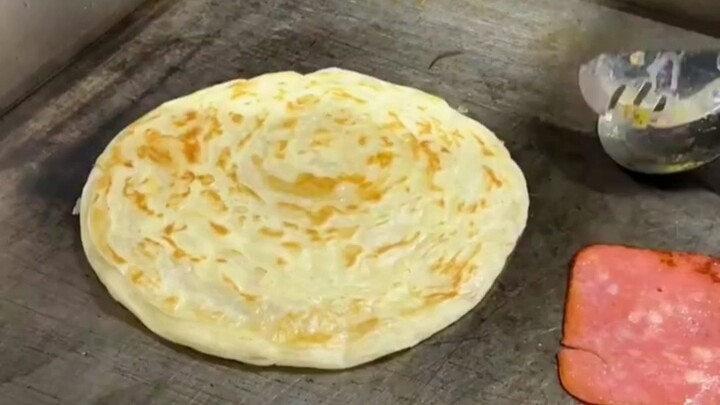 The hand-pancake vendor says he's going to show off his signature skill.