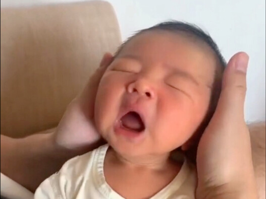 A just-one-week-old baby looks so adorable sneezing!