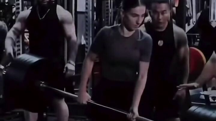 The female powerhouse at the gym has no ulterior motives—only genuine admiration for true strength!