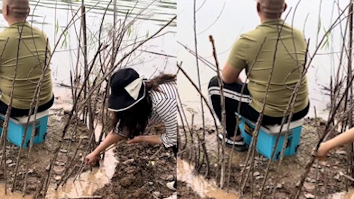 A man was fishing leisurely, while his wife was bored and dug a ditch and inserted branches into it.