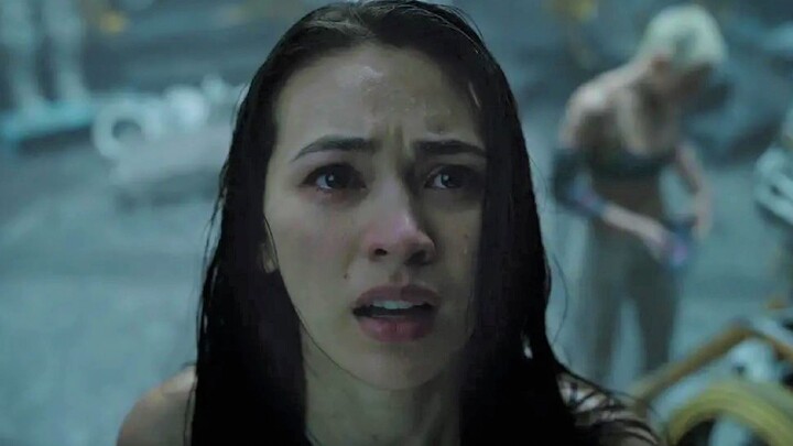 Five men and women are trapped in the deep sea, changing into wetsuits in full view, while a giant c