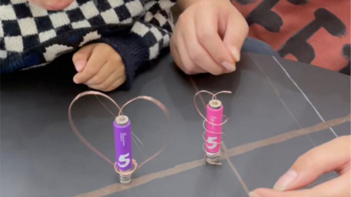 One No. 5 battery, a short piece of thin copper wire, and five small circular magnets—join your chil