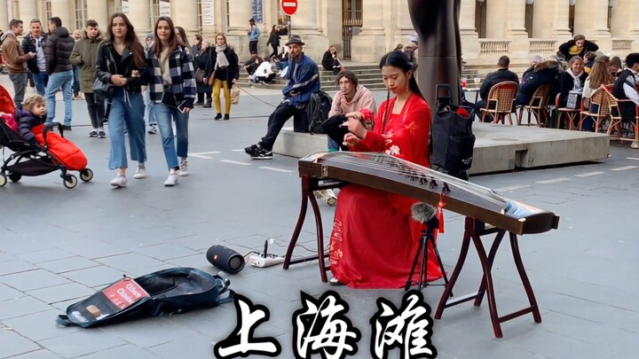What was the idea behind playing "Shanghai Beach" on a guzheng in the streets of France? First of al