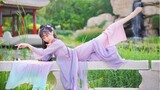A girl dancing in a purple traditional Chinese costume