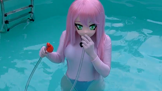 Little girl Kigurumi blowing balloons playing in the water, Chom Jam