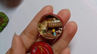 A miniature setting in the tin of essential balm
