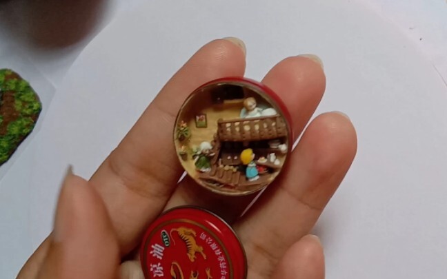 A miniature setting in the tin of essential balm