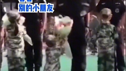 เด็กน้อยคุกเข่าข้างเดียวมอบดอกไม้ให้คุณตำรวจ