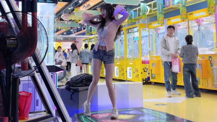 Shorts, a petite waist, and long legs—this confident young lady jams on the dance pad, swaying her h