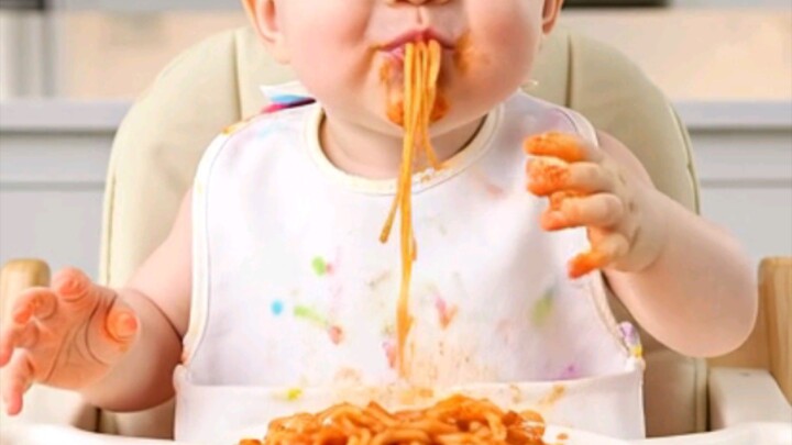 Baby enjoying spaghetti for the first time! That messy smile is everything 🥰#baby #cute #spaghetti