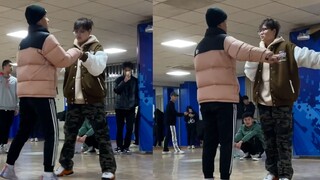 Ruthless dancing machine: Two boys team up to perform a rumba dance in PE class, their limbs stiff a