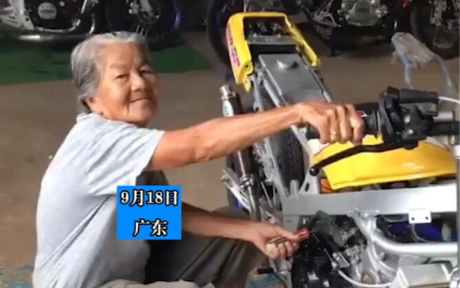 Old lady mechanic masters her craft: tunes the car by ear, with a confident expression.