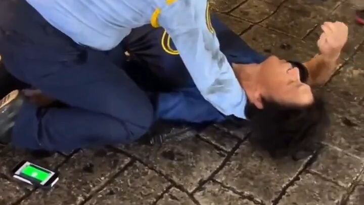 Guy gets tackled by a police officer and his wig falls off