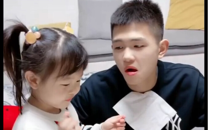 Yu’er imitates the grown-ups by feeding the baby, and her older brother’s “I’ve lost all will to liv