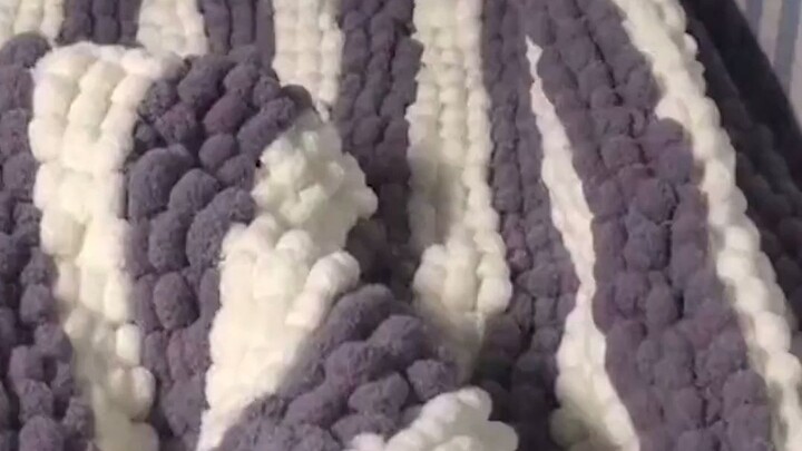 The guy received a quilt from his girlfriend, hand-knitted with yarn, and he was instantly overwhelm