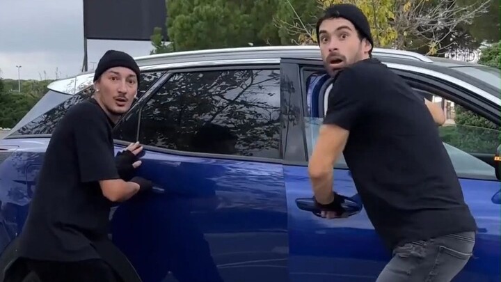 The thief was stealing things when someone grabbed their hand and stopped them.