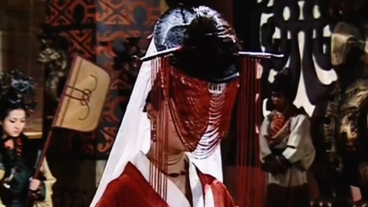 It only makes sense if she lifts the veil to reveal her face and blow everyone away...