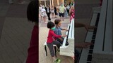 Two amazing talented 6-year-old kids playing duet on a public street piano