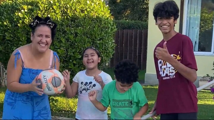Cute son helps mom and siblings in the pool.