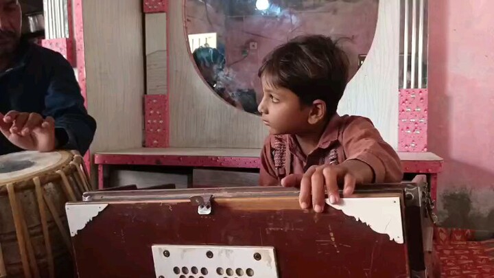 my nephew playing harmonium