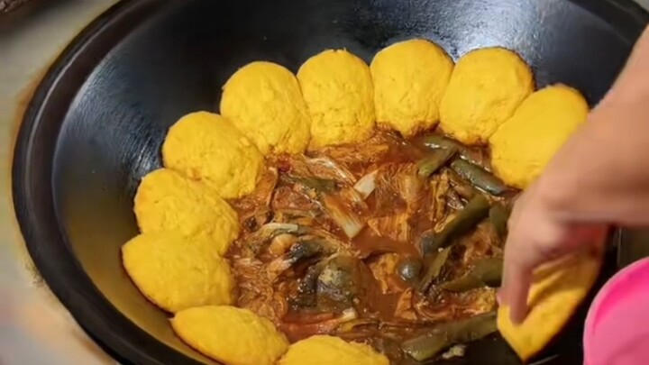 Northeast-style fermented bean paste stew in an iron pot—three corn pancakes per meal
