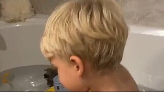 baby at bath tub playing