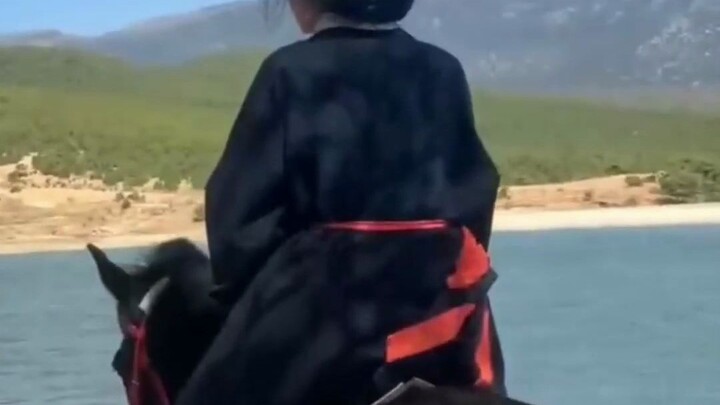 A woman in traditional attire rides horseback; the photographer: “The moment she turned to look back