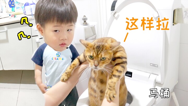 The cat teaches the kid how to use the toilet—one dares to teach, and the other dares to learn!