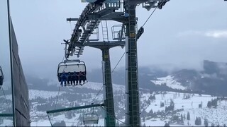 Young Skiers Sing On Chair Lift