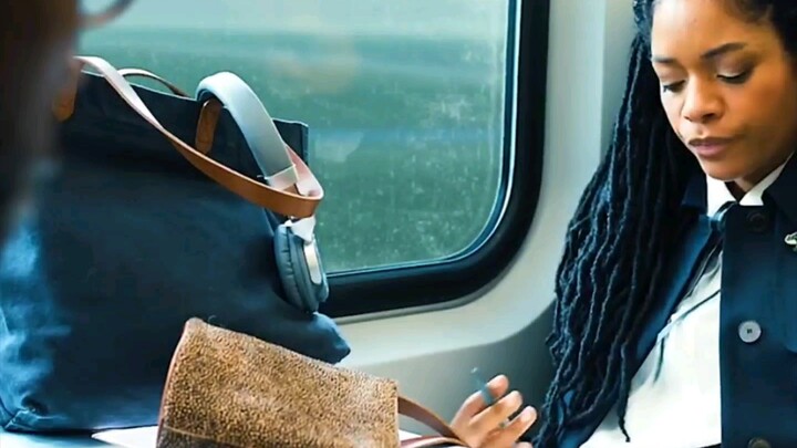 A young man eats the girl's chocolate on the train.