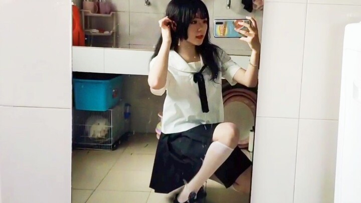 College girl in a JK uniform pairs her pleated skirt with classic knee-high socks. The short skirt h