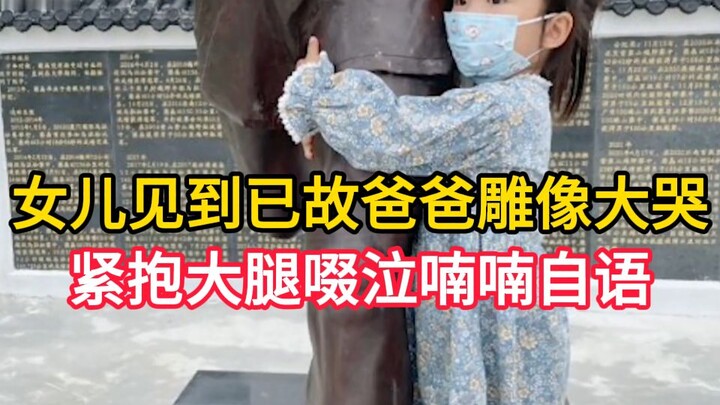 Daughter bursts into tears upon seeing a statue of her late father, clutching his leg as she sobs an