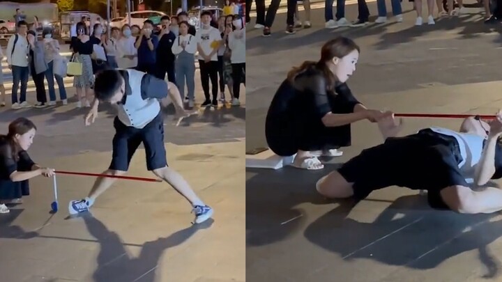 The young man showed off his waist bending over a very low horizontal bar on the street. His super w
