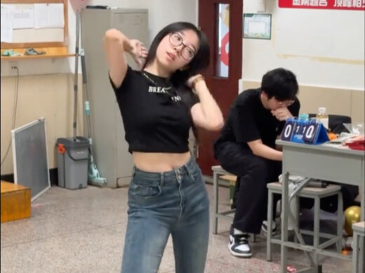 What are the boys behind doing while the girls in class are dancing?