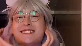 What does it look like when a boy dances with a wig?