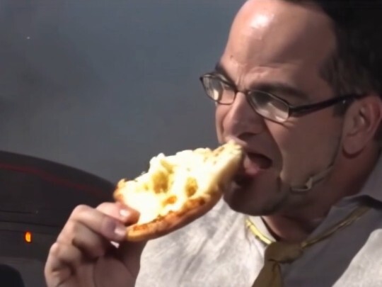 Muscular arms eating cream pizza crumbs
