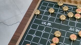 The chess robot, on its last legs, resorts to unfair tactics and tries to ambush me.