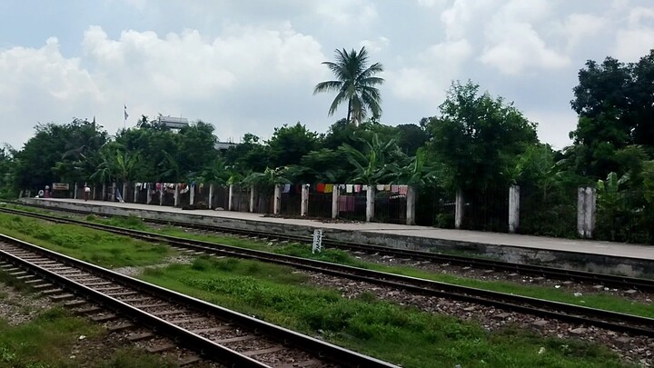 FVP View from the train passing a station (Jinardi Railway Station, Narsingdi) in Bangladesh.