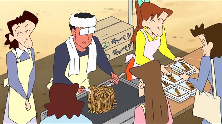The shiny noodles dance joyfully in the iron wok, instantly coated with an enticing sauce-colored gl